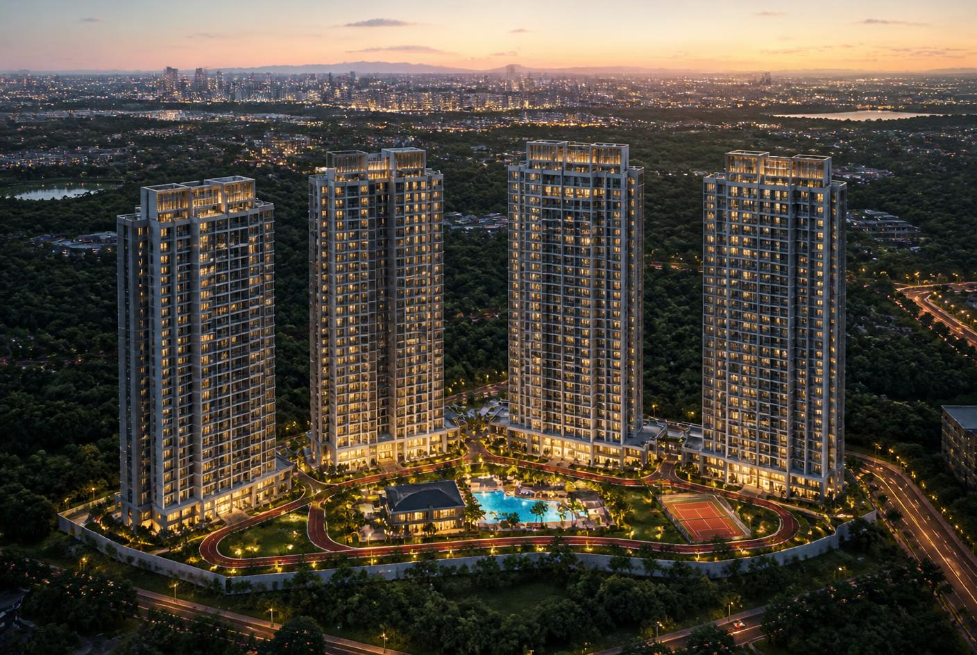 Aerial dusk view of the illuminated residential towers and amenity deck